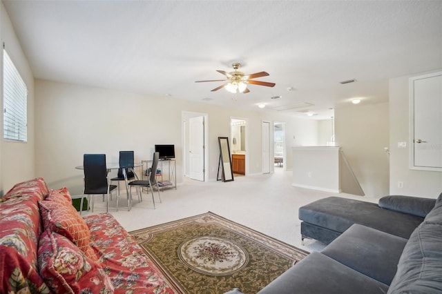 living room featuring carpet flooring and ceiling fan