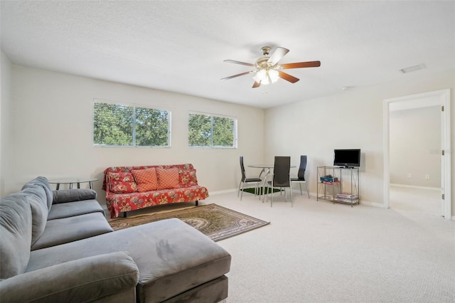 carpeted living room featuring ceiling fan