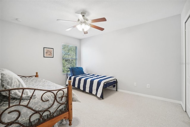 bedroom featuring ceiling fan and light carpet