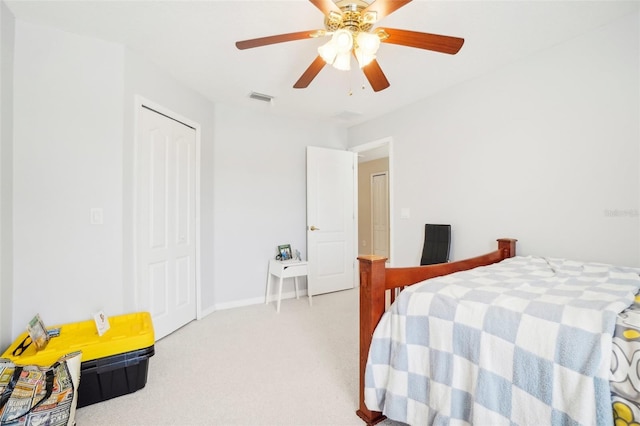 carpeted bedroom featuring a closet and ceiling fan