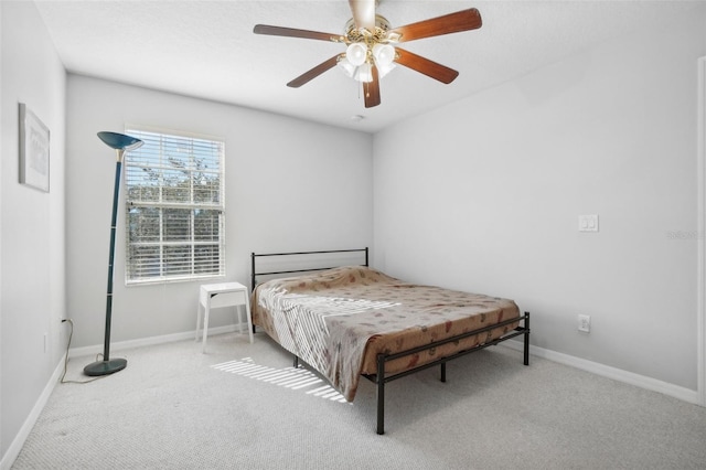 bedroom with ceiling fan and light carpet