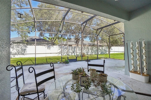 view of patio featuring glass enclosure