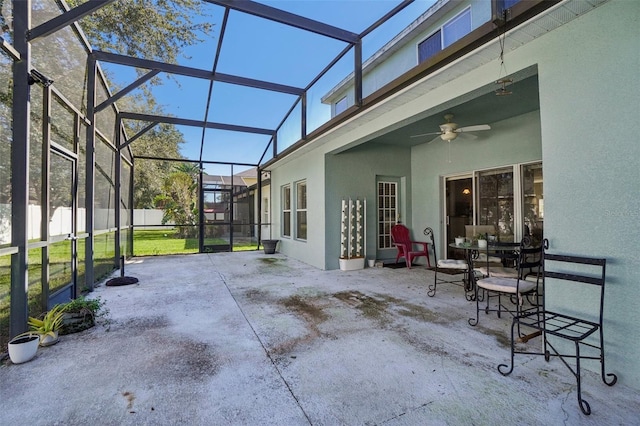 view of patio / terrace with ceiling fan and glass enclosure