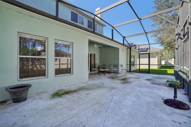 view of patio / terrace with ceiling fan and a lanai