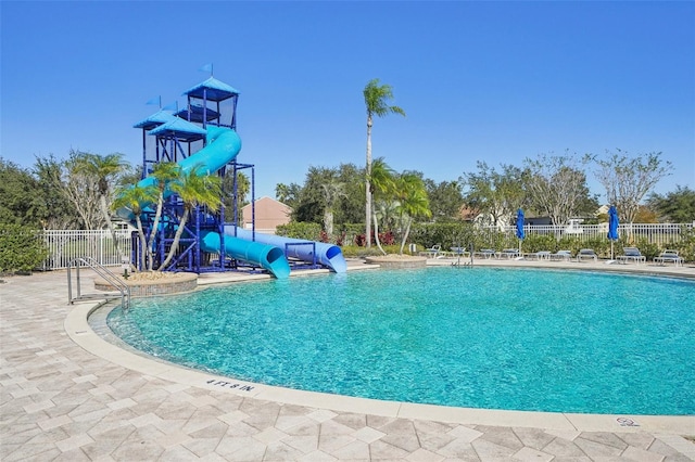 view of swimming pool with a patio area and a water slide