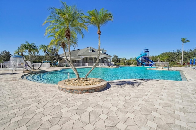 view of pool featuring a patio, pool water feature, and a water slide