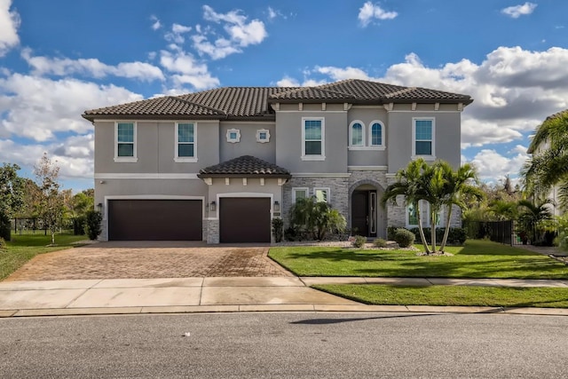 mediterranean / spanish house with a front lawn and a garage