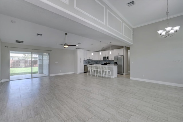 unfurnished living room featuring ceiling fan with notable chandelier, crown molding, and lofted ceiling