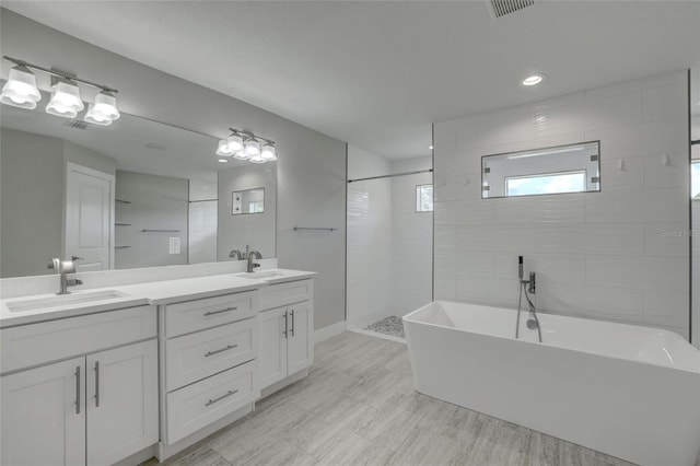 bathroom featuring vanity and separate shower and tub