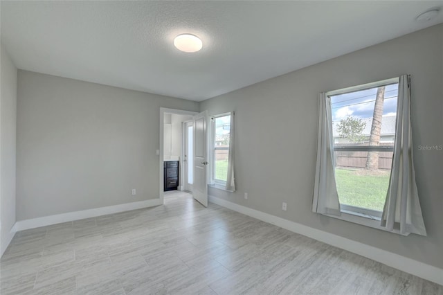 spare room featuring a textured ceiling