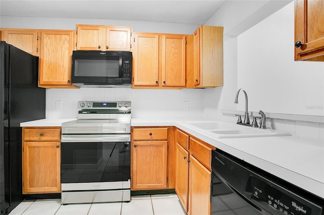 kitchen with decorative backsplash, sink, light tile patterned floors, and black appliances