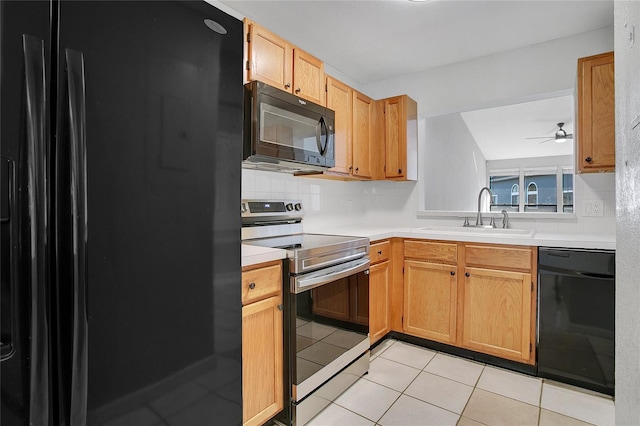 kitchen featuring ceiling fan, sink, light tile patterned floors, and black appliances