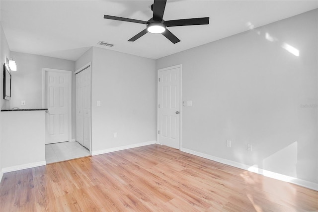 unfurnished room featuring ceiling fan and light wood-type flooring