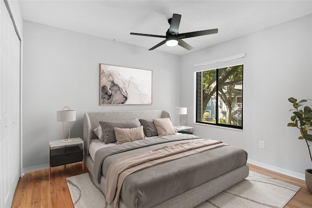 bedroom featuring wood-type flooring, a closet, and ceiling fan