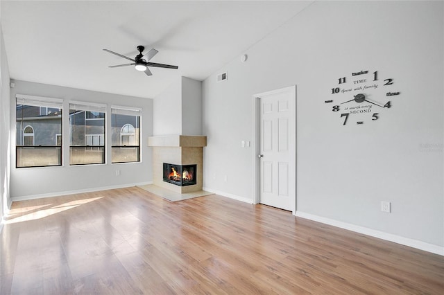 unfurnished living room featuring a multi sided fireplace, ceiling fan, light hardwood / wood-style flooring, and lofted ceiling