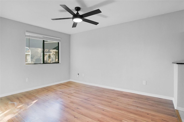 spare room featuring light hardwood / wood-style flooring and ceiling fan