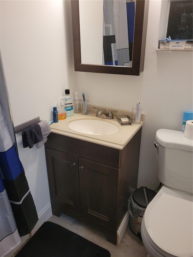 bathroom featuring vanity and toilet