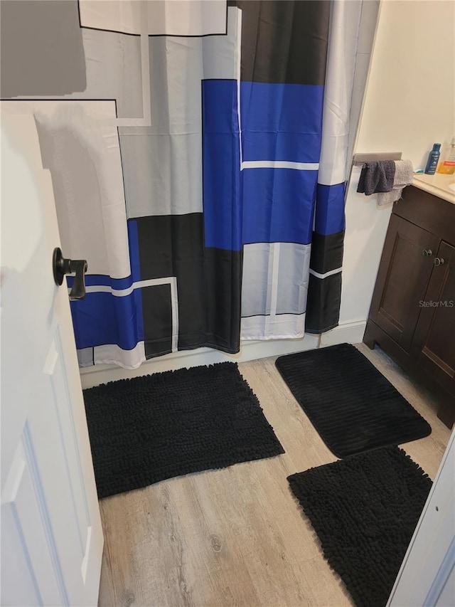 3458 NW 28th Ave, Okeechobee, FL 34972 - full bathroom with wood finished floors and curtained shower
