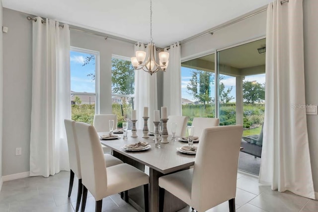 tiled dining area featuring a notable chandelier