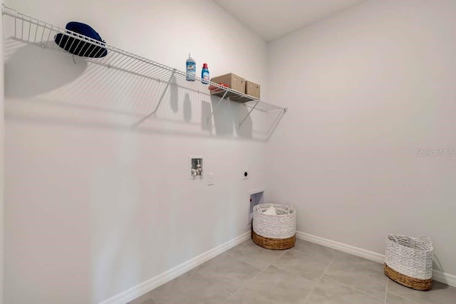 clothes washing area with tile patterned flooring, washer hookup, and hookup for an electric dryer