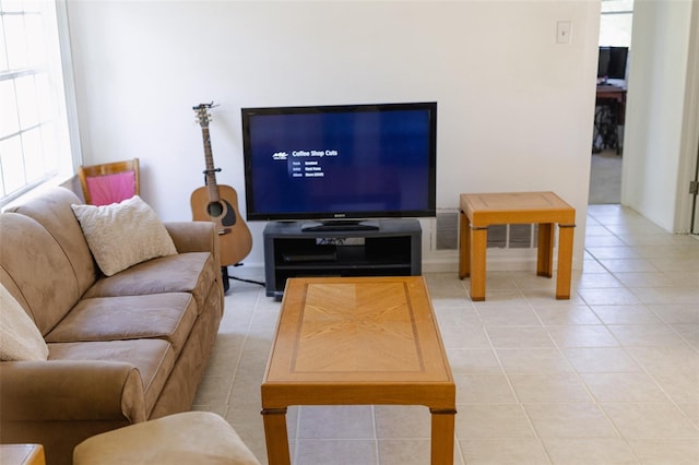 living room featuring a healthy amount of sunlight and light tile patterned floors