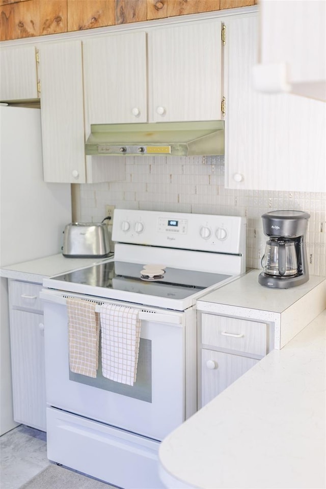 kitchen featuring backsplash and white range with electric stovetop