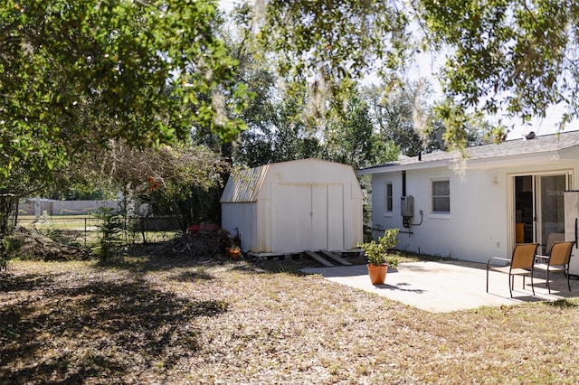 view of yard featuring a patio and a storage shed