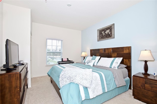 bedroom featuring light colored carpet