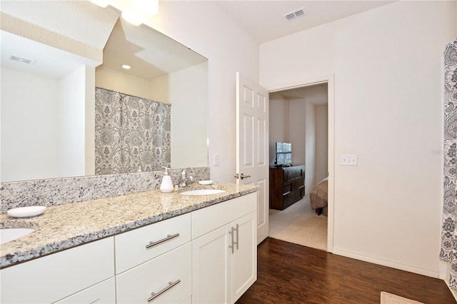 bathroom with vanity and hardwood / wood-style flooring