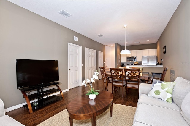 living room featuring dark wood-type flooring