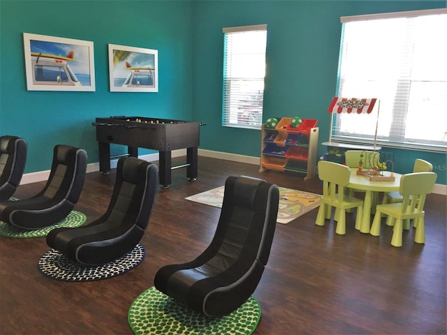 game room with dark wood-type flooring