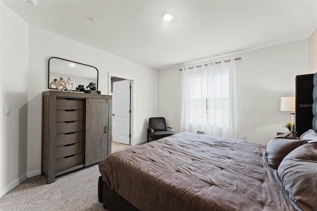 carpeted bedroom with a textured ceiling