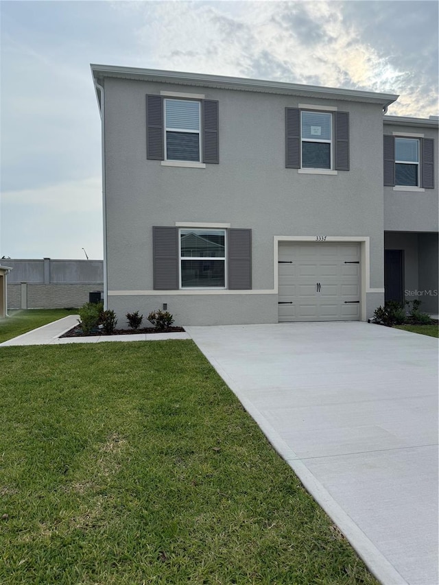 3337 Private Oak Dr, Apopka, FL 32703 - view of front facade with driveway, stucco siding, a front lawn, and a garage