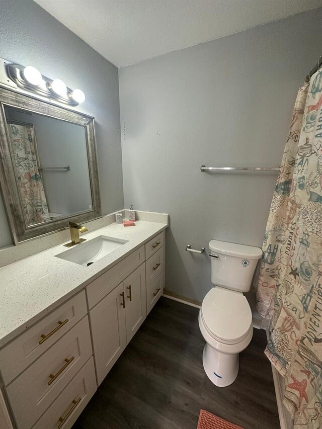 1023 S Hiawassee Rd Unit 4022, Orlando, FL 32835 - bathroom featuring wood finished floors, vanity, toilet, and a textured ceiling