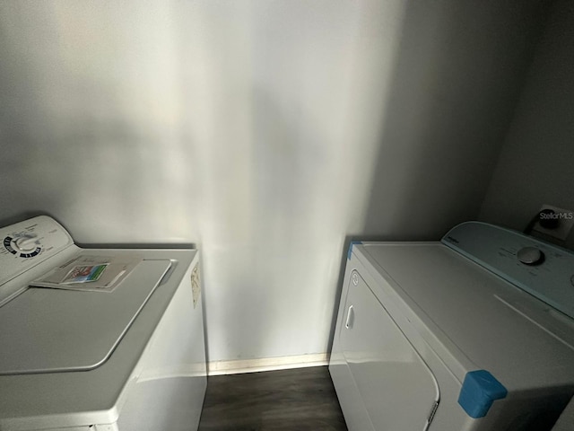 laundry room with hardwood / wood-style floors and separate washer and dryer