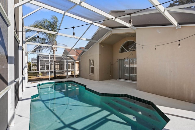 view of swimming pool featuring a patio and glass enclosure