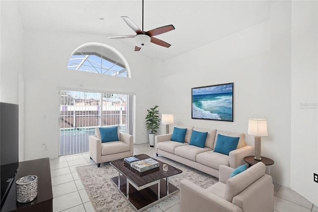 tiled living room featuring ceiling fan and high vaulted ceiling