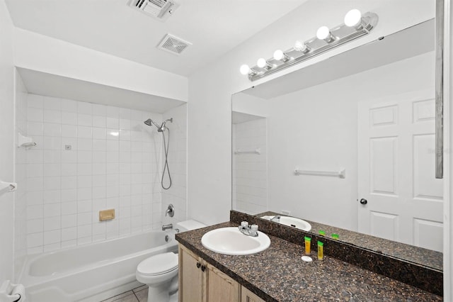 full bathroom featuring tile patterned floors, vanity, toilet, and tiled shower / bath combo