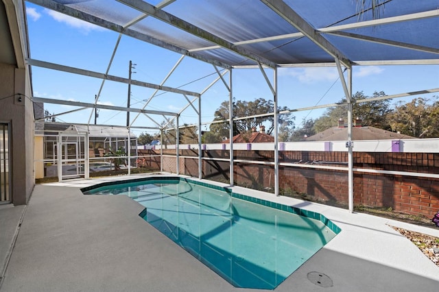 view of swimming pool with a lanai and a patio