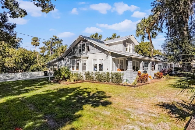 back of house with a lawn