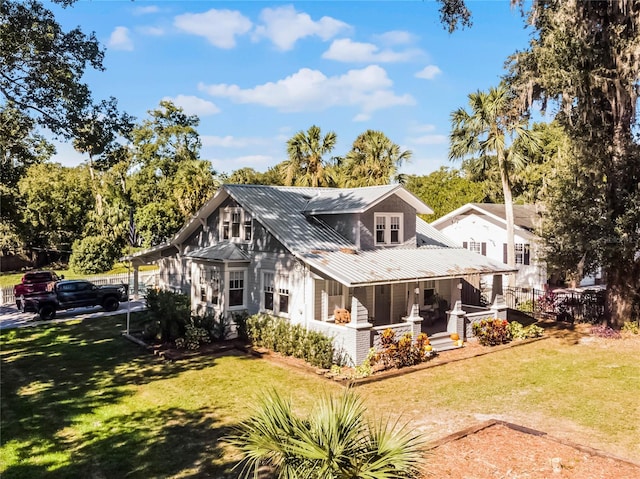 exterior space featuring a front lawn and covered porch