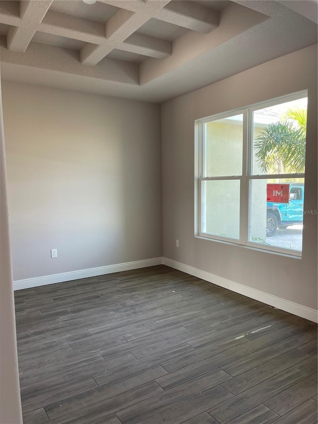 unfurnished room featuring coffered ceiling, dark hardwood / wood-style floors, and beamed ceiling