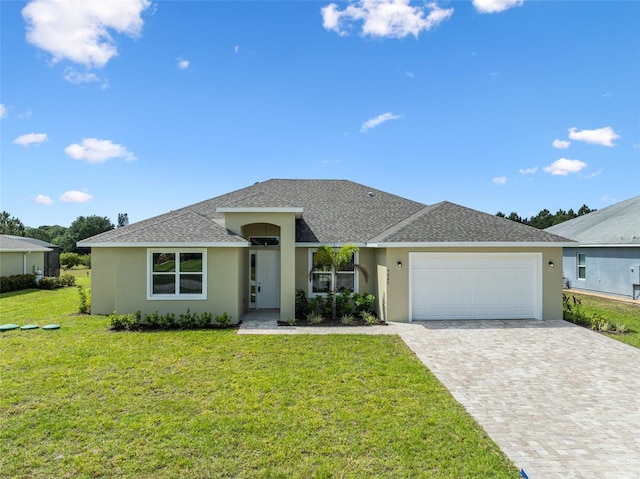 ranch-style home featuring decorative driveway, a front lawn, a shingled roof, an attached garage, and stucco siding