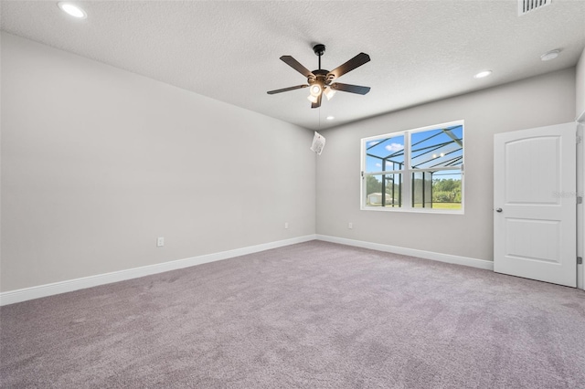 spare room featuring recessed lighting, carpet, a textured ceiling, and ceiling fan