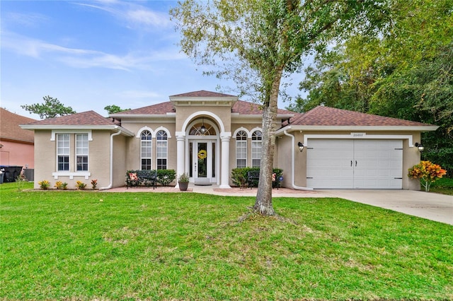 mediterranean / spanish-style home with a garage and a front yard