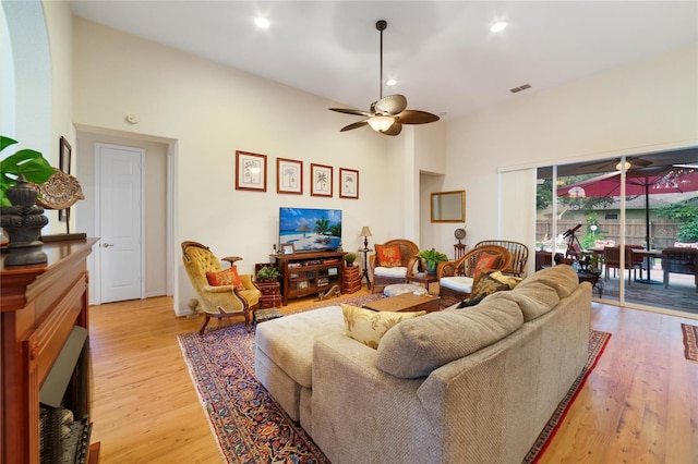 living room featuring ceiling fan and light hardwood / wood-style flooring