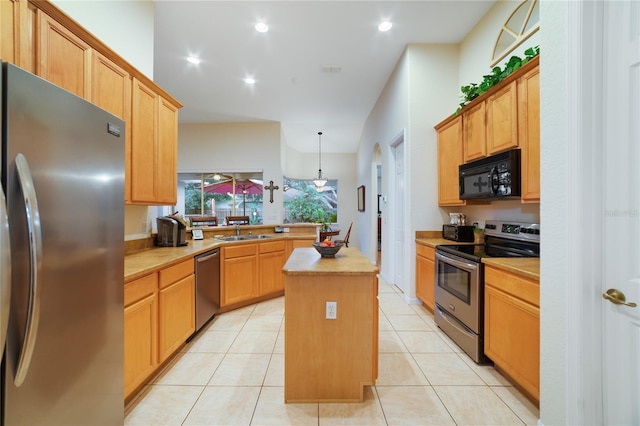 kitchen featuring a center island, sink, hanging light fixtures, light tile patterned floors, and stainless steel appliances