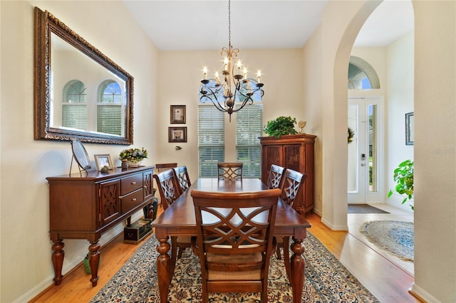 dining area featuring a chandelier and light hardwood / wood-style flooring