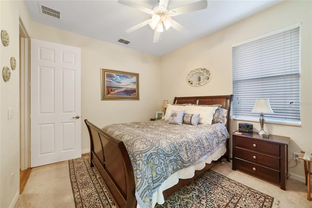 bedroom featuring ceiling fan and light carpet