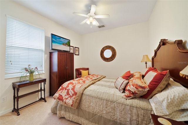 bedroom with light colored carpet and ceiling fan